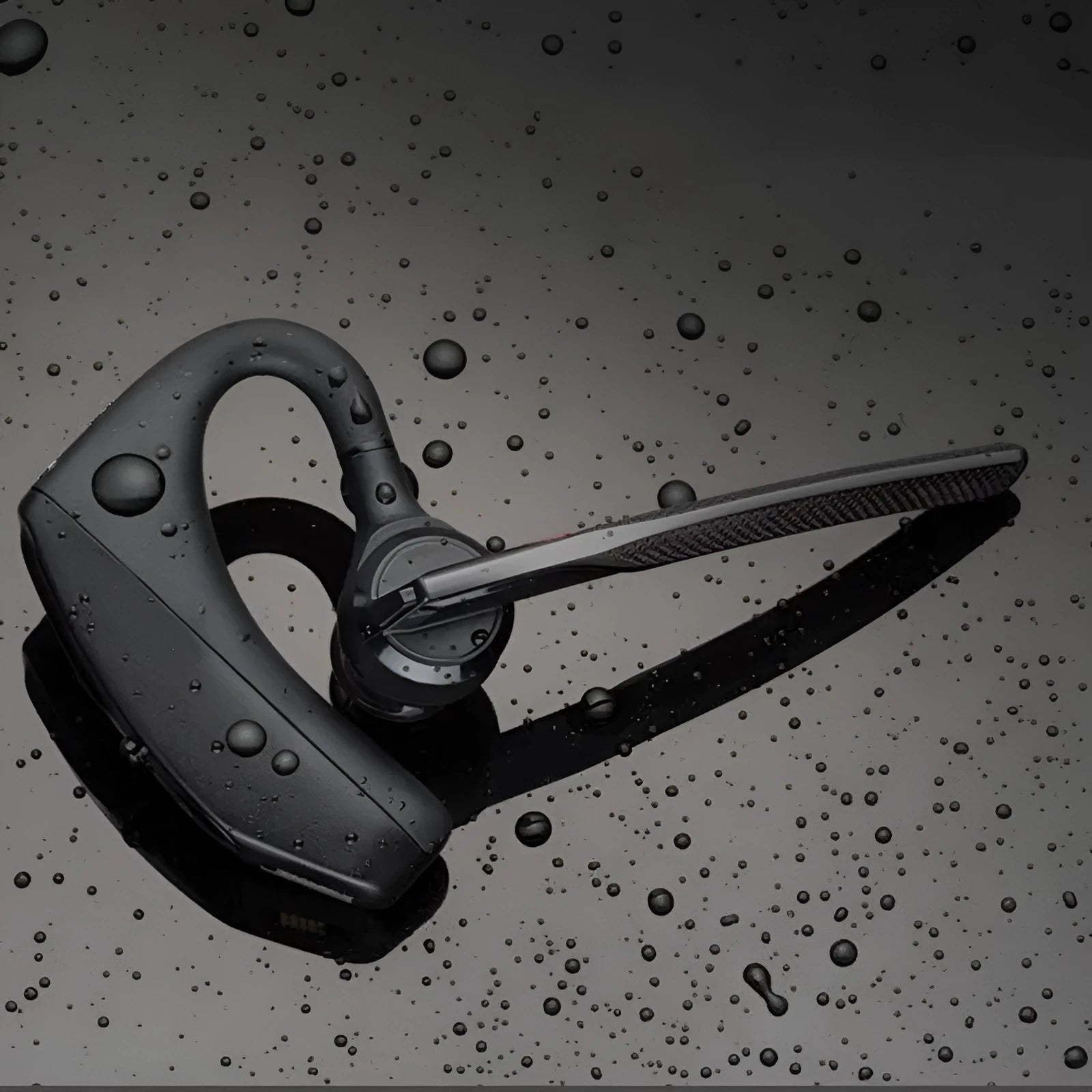 Black plastic Bluetooth sports headphones showing a battery display and USB connection.