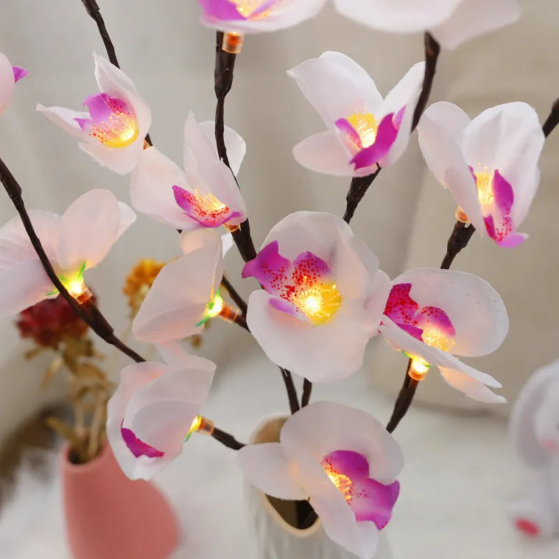 Pink LED Phalaenopsis orchid branch decorative light measuring 65cm long for bedroom walls.