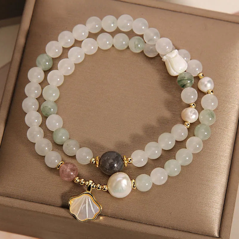 Women's crystal bracelet with gold-plated inlay, gemstones, and a Tianshan Jade ginkgo leaf pendant.