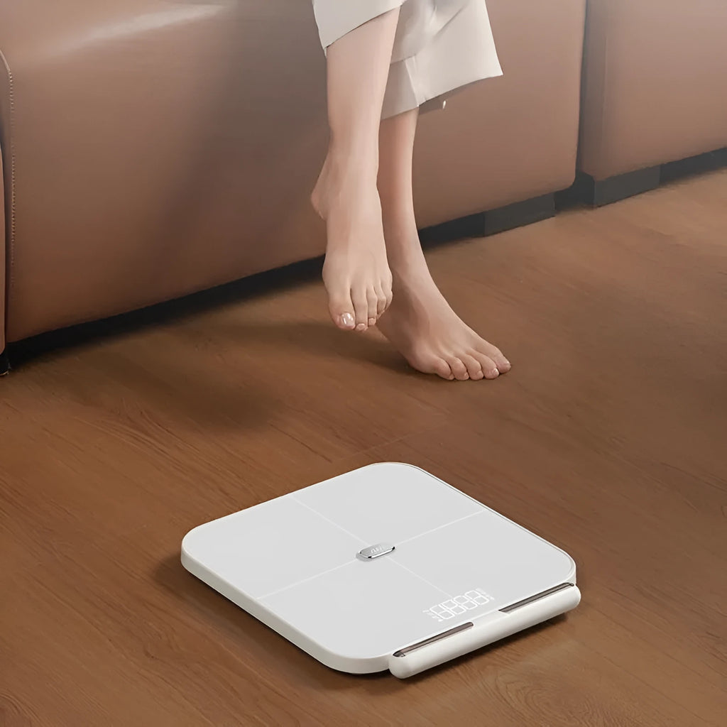 White professional body fat scale with 8 electrodes on tempered glass platform