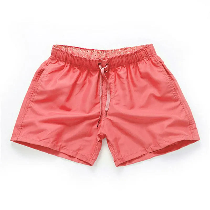 Men's black polyester beach shorts with a straight leg, shown on a size chart with options up to 4XL.