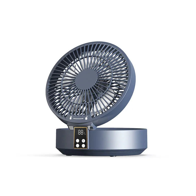 White portable folding fan with remote control on wooden desktop next to USB charging cable