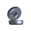 White portable folding fan with remote control on wooden desktop next to USB charging cable