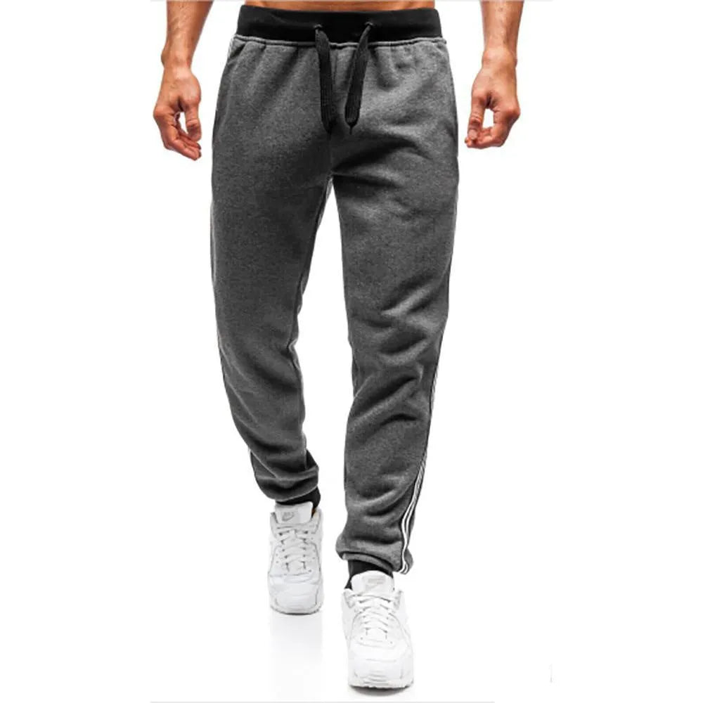 Men's summer casual loose tapered sports trousers in black with elastic waist, drawstring, and stitching details