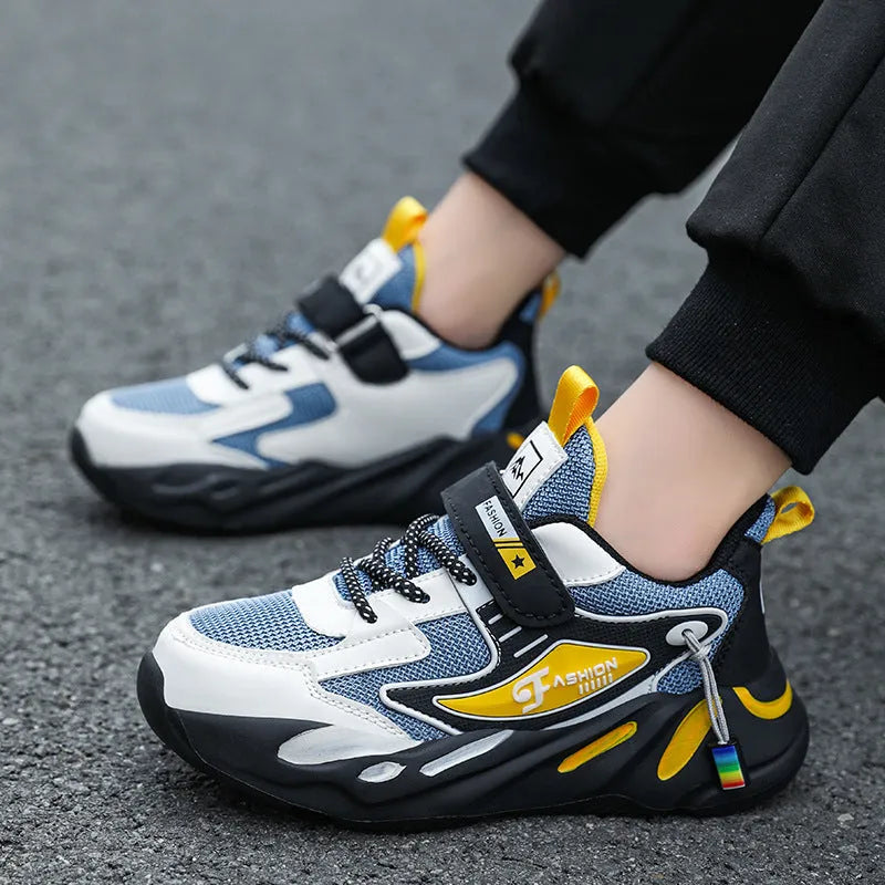 Boys dark blue and beige sports running shoes with Velcro strap and mesh upper.