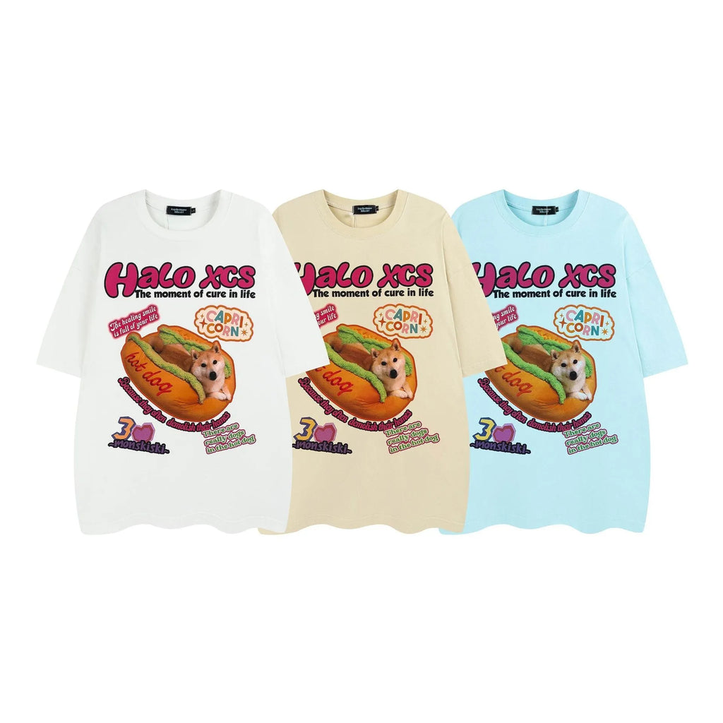 White cotton t-shirt with a cartoon print of a hamburger and a dog, showing a round neck and short sleeves.