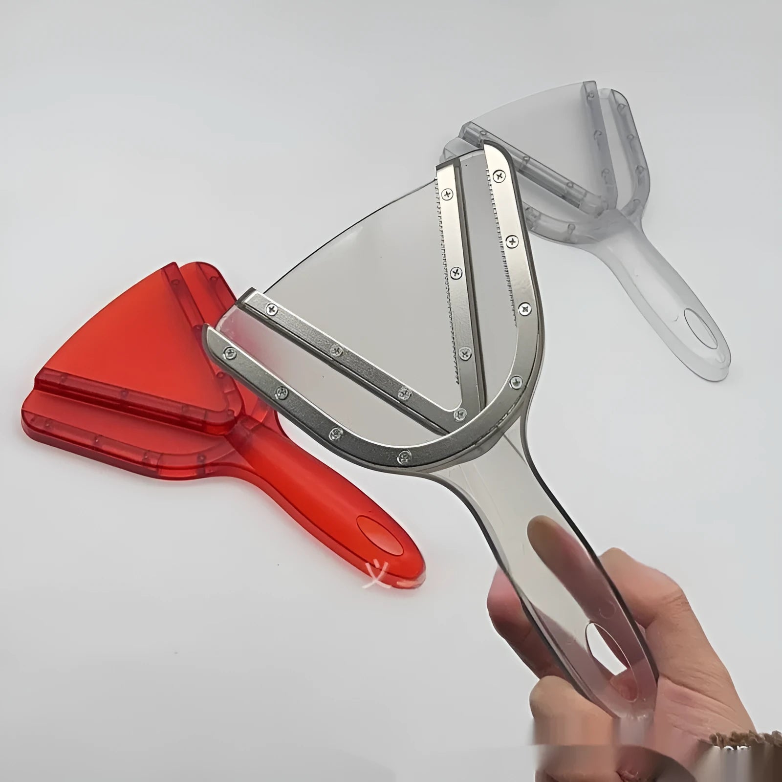 Red telescopic bottle opener with non-slip jaws, shown extended on a kitchen counter.