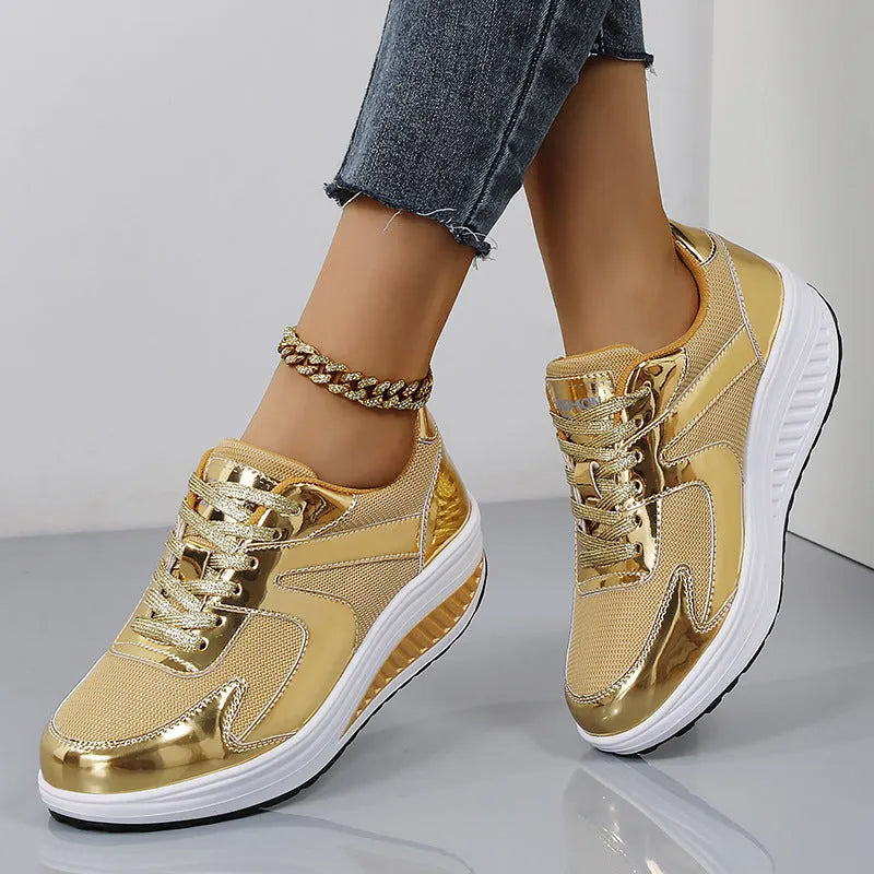 Women's gold platform trainers with mesh upper and cross-strap design showing 3-5cm heel elevation