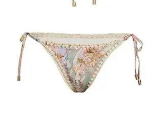 Creamy white floral print women's bikini set with matching skirt on a mannequin.