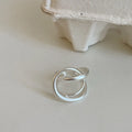 Geometric open ring with interlaced design in matte gold metal finish