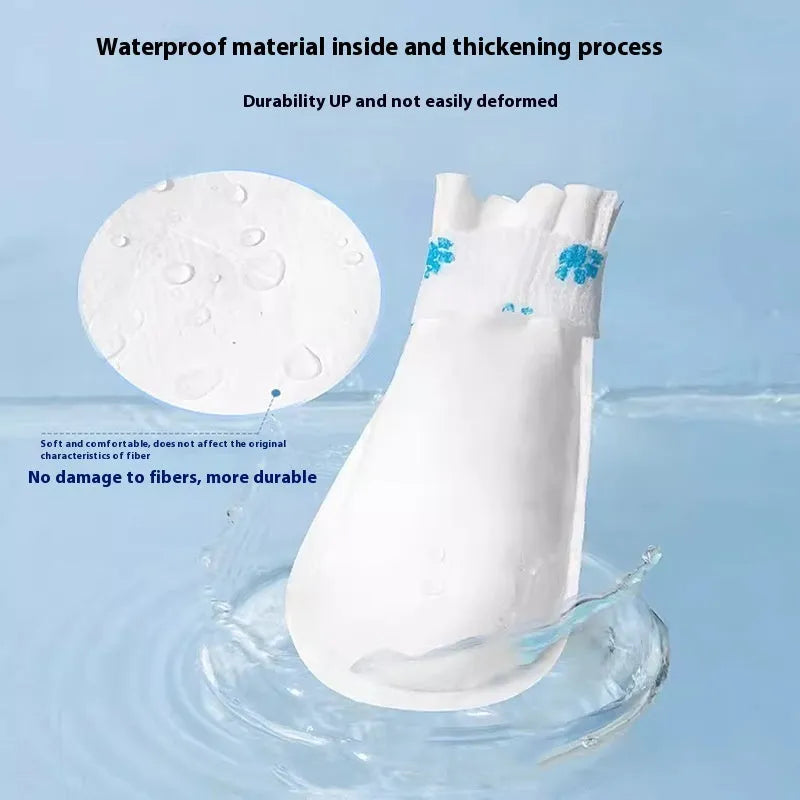 Pack of 20 white disposable waterproof shoe covers for small and medium dogs on a non-slip surface.