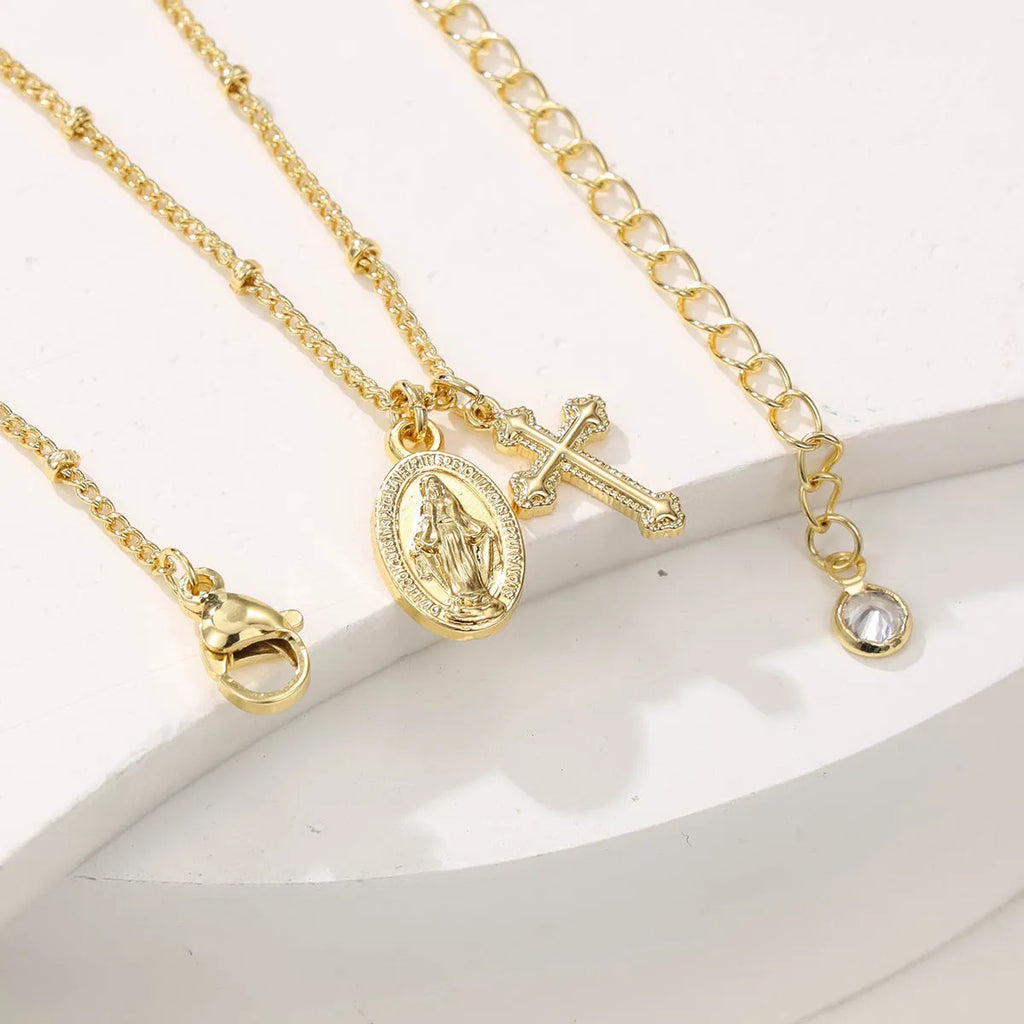 Gold cross Virgin Mary pendant necklace with geometric design on adjustable chain for women