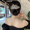 Alloy metal hair curler in fish tail style on a neutral background