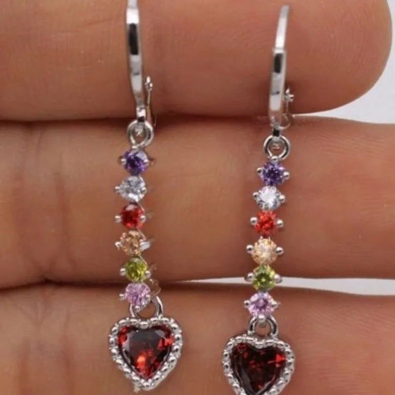 A pair of women's heart-shaped alloy earrings with a shiny electroplated gold finish.