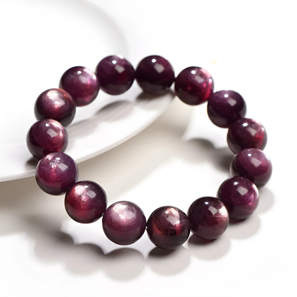 Close-up of a handcrafted purple lepidolite crystal bracelet with polished round beads on a wrist.