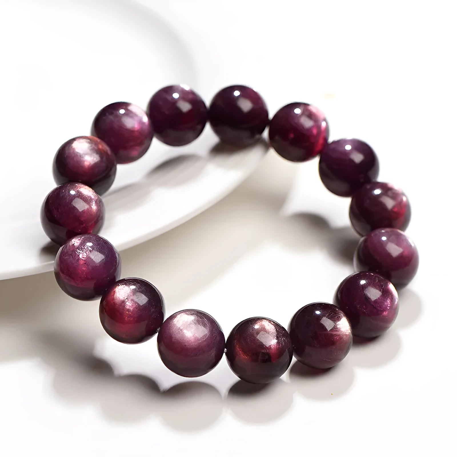 Close-up of a handcrafted purple lepidolite crystal bracelet with polished round beads on a wrist.