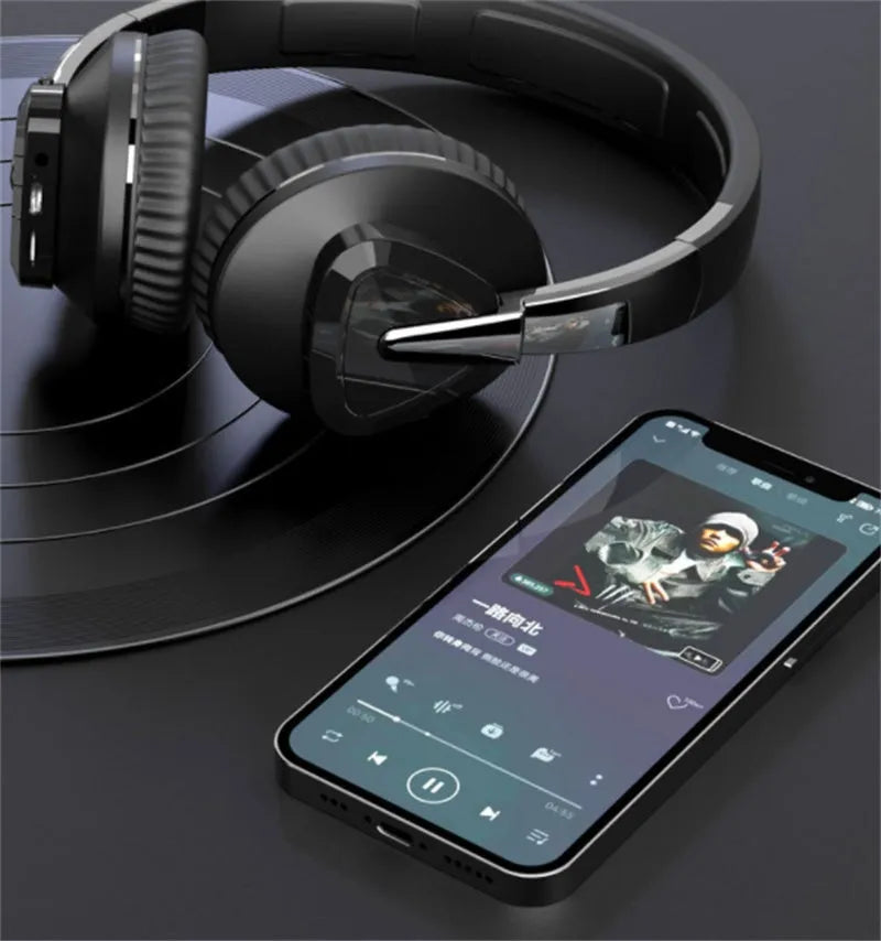 Wireless over-ear headset in black with soft ear cushions, showing AUX audio jack port.