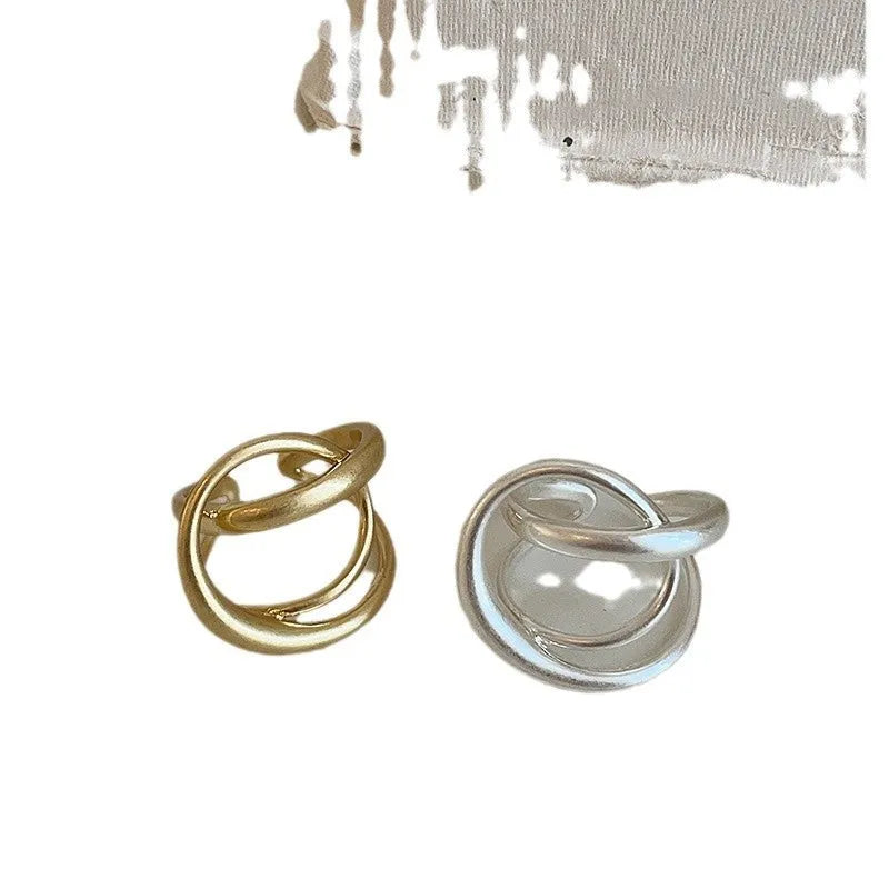 Geometric open ring with interlaced design in matte gold metal finish