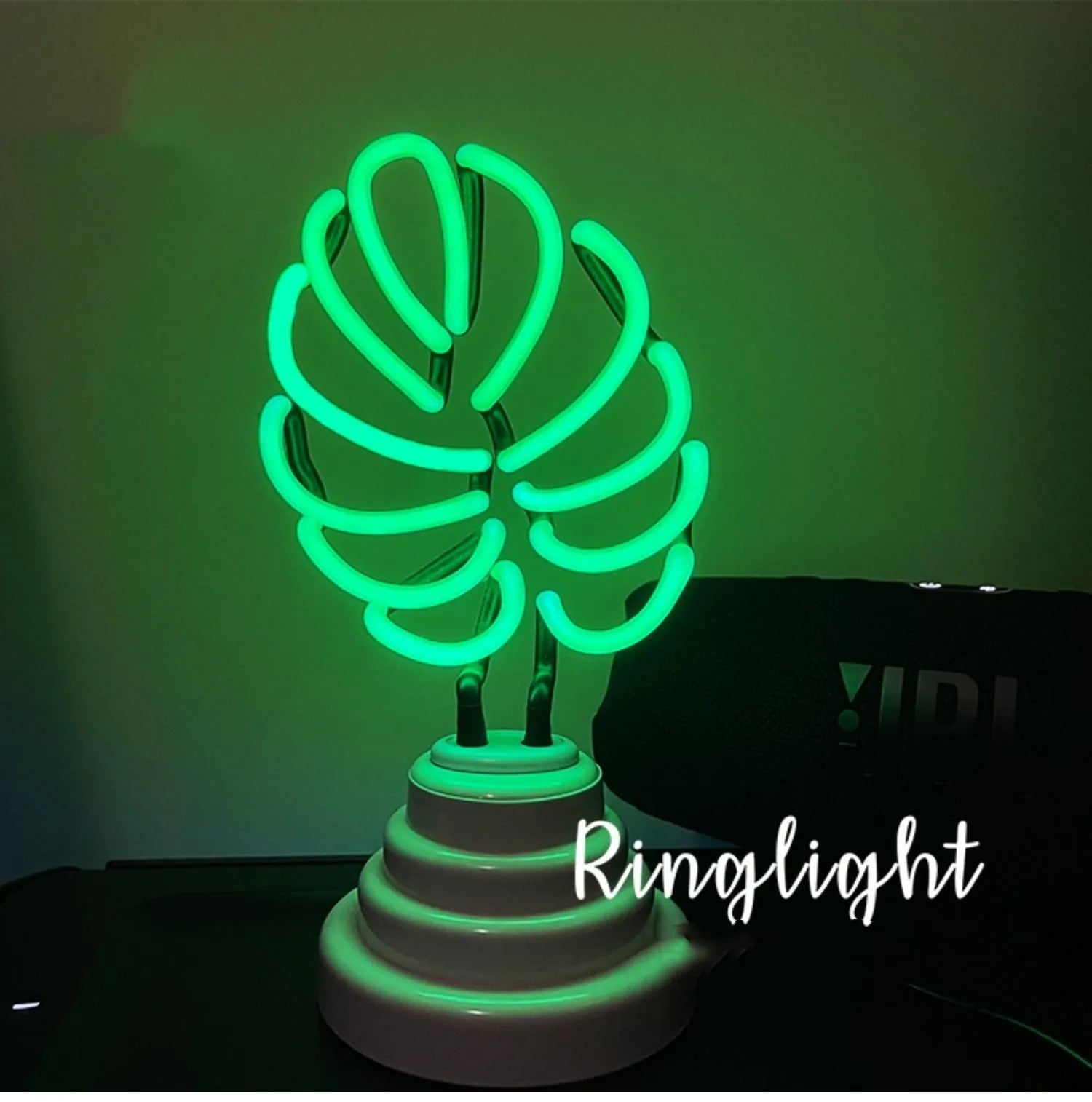 White bamboo-shaped desktop lamp emitting green light with USB power cable
