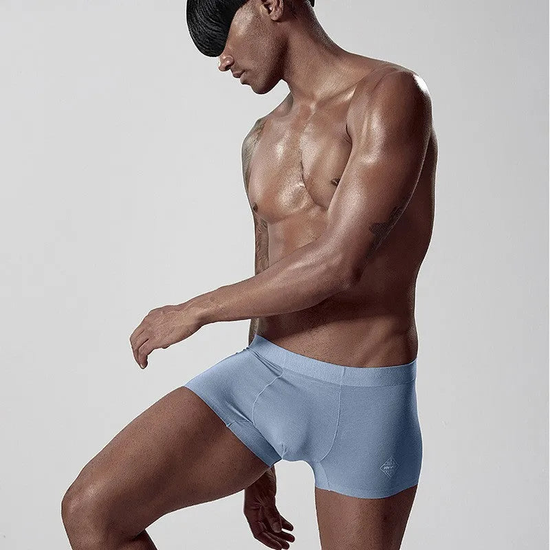 Seamless one-piece men's modal underwear in mid-waist design shown in green colour