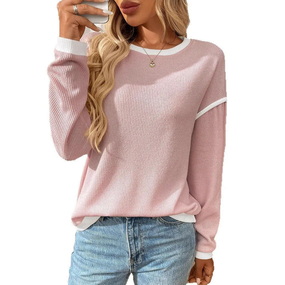 Women's loose round neck long sleeve polyester pullover top in light blue on a hanger.