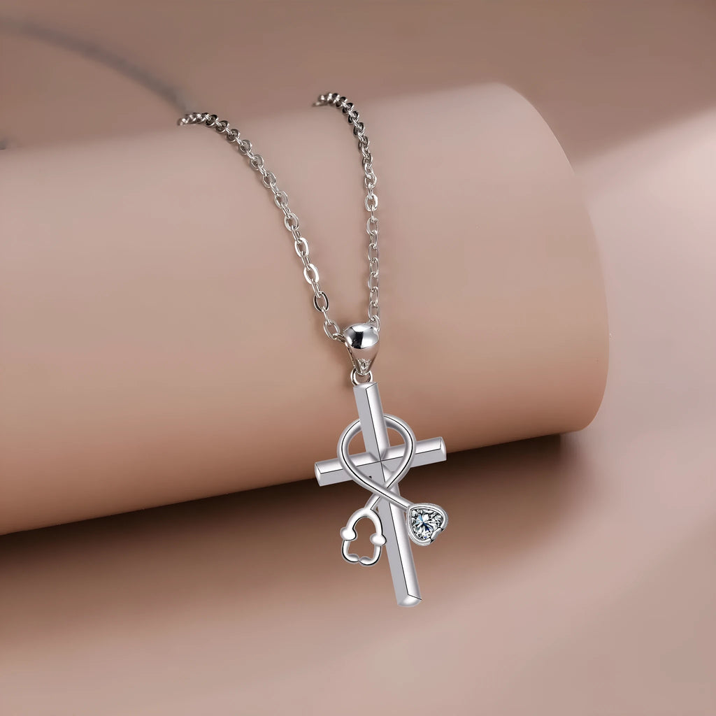 Copper cross necklace with a detailed stethoscope pendant on a chain.