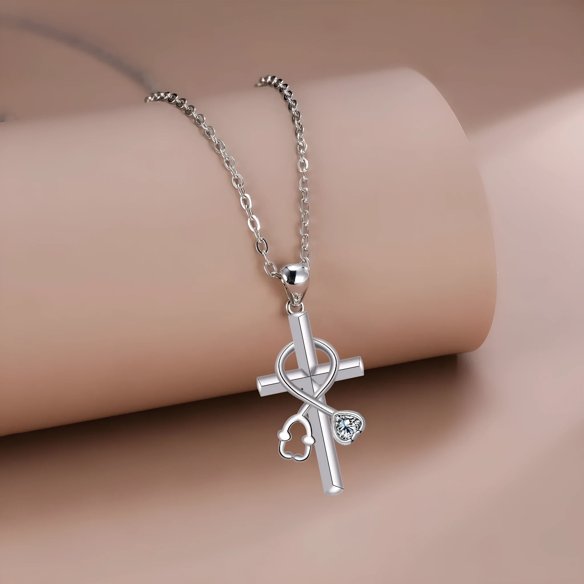 Copper cross necklace with a detailed stethoscope pendant on a chain.