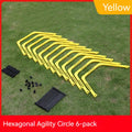 Set of six foldable yellow, green, and orange hexagon football agility training rings on grass