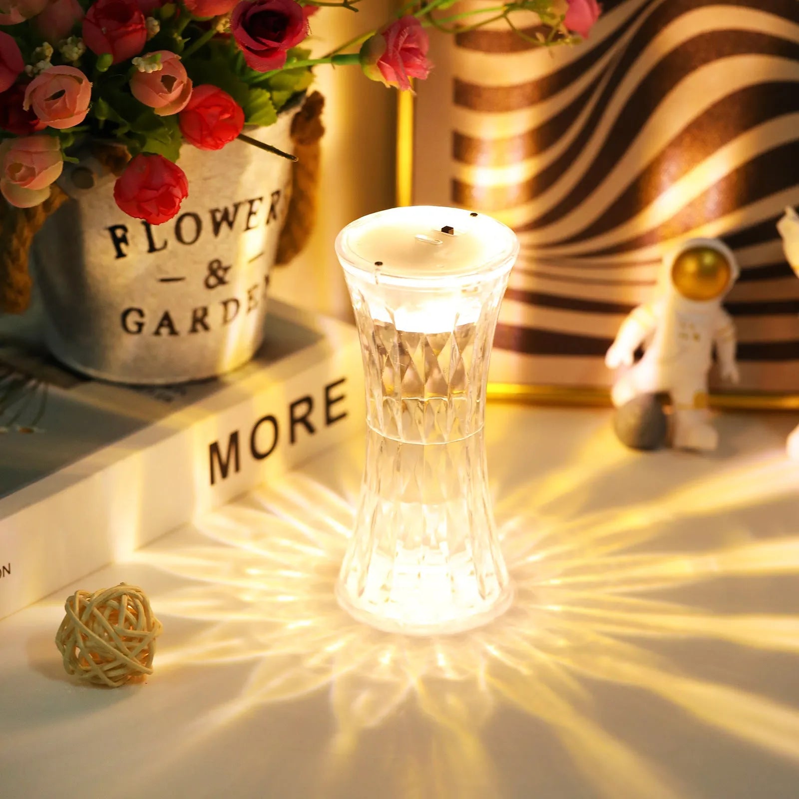 Clear acrylic crystal rose petal table lamp with plastic LED, warm white light, compact 12.2cm size on a desk