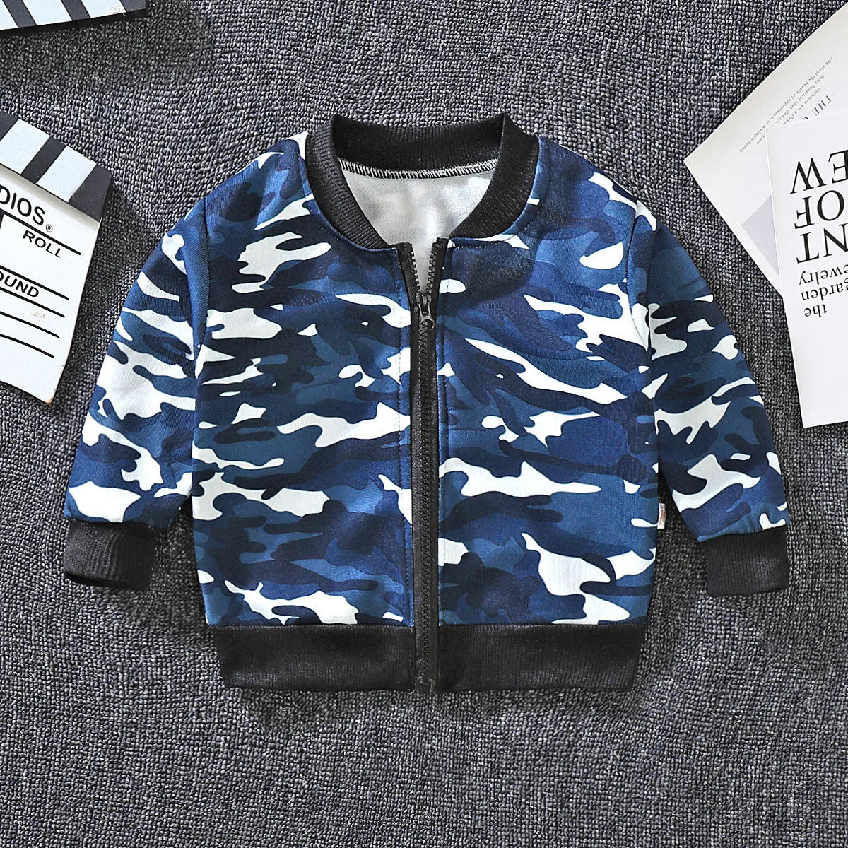 Children's Korean baseball jacket in beige with animal print, V-neck, long sleeves, non-hooded, on child.