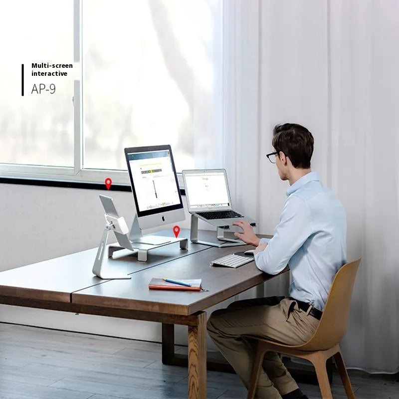 Black aluminium alloy foldable laptop stand with adjustable tilt on desktop