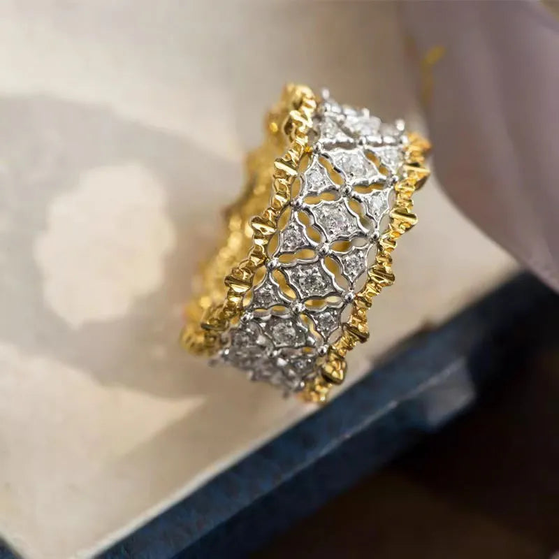 Geometric two-tone copper ring with a round zircon stone, shown in gold colour.