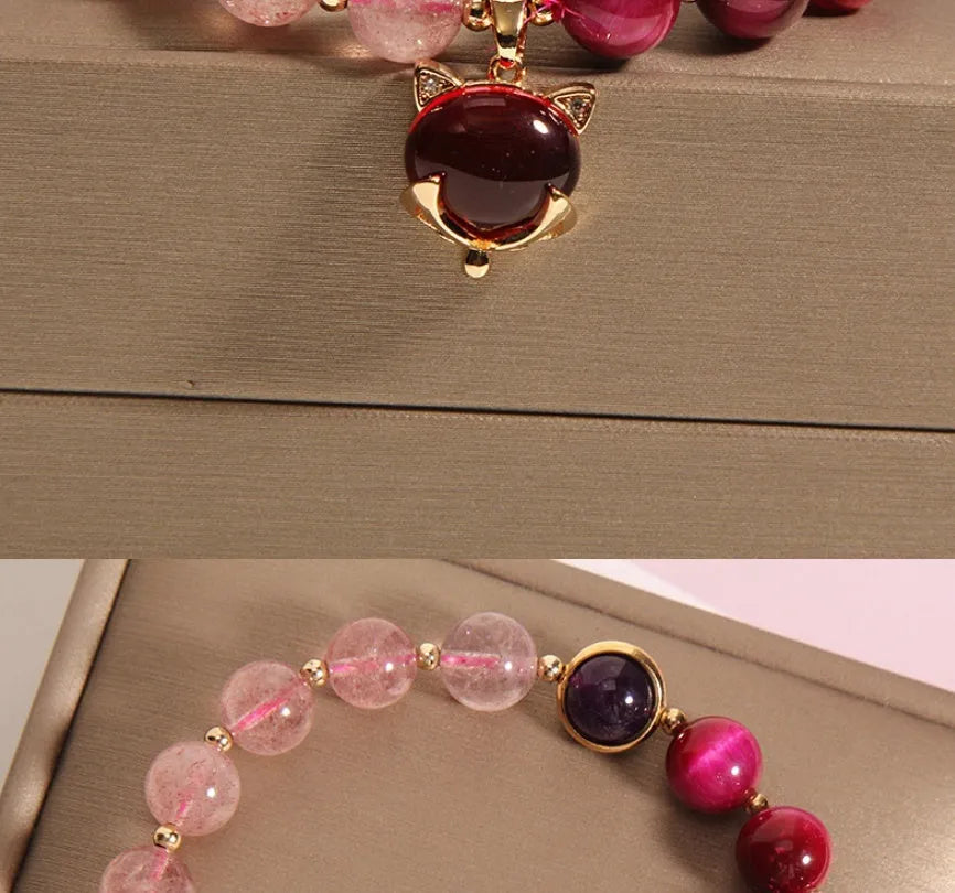Simple women's bracelet with a strawberry crystal on a black elastic rope.