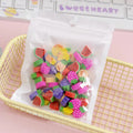Assortment of 50 colourful cartoon-themed mini erasers including fruit, animal, and holiday designs.
