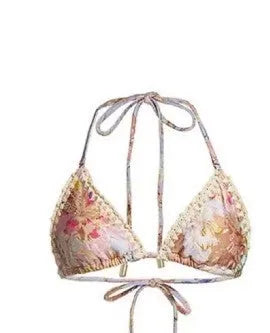 Creamy white floral print women's bikini set with matching skirt on a mannequin.