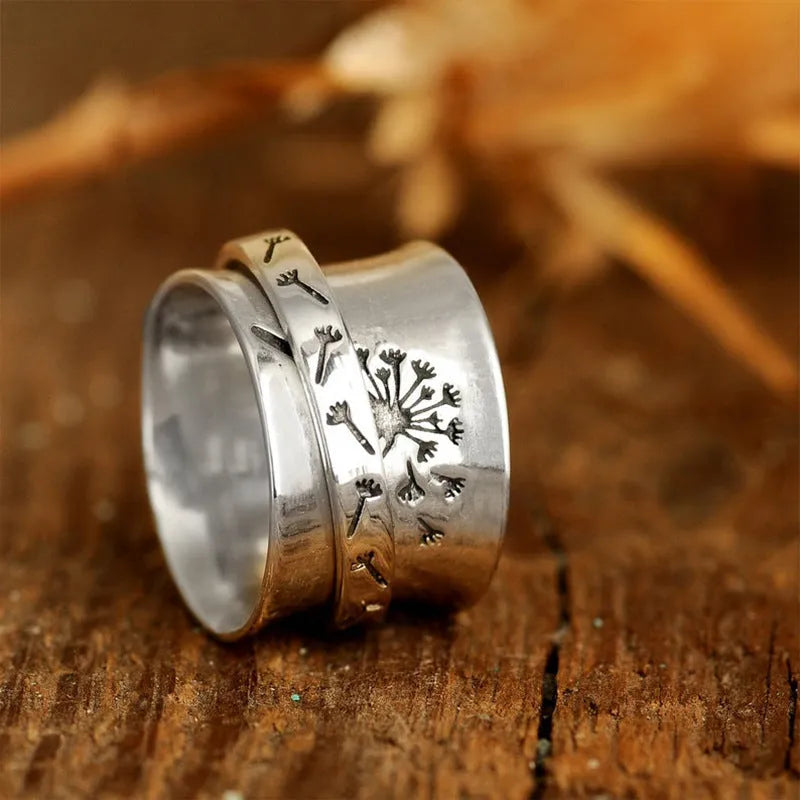 Silver-colour rotating flower ring showing floral element that moves independently of band