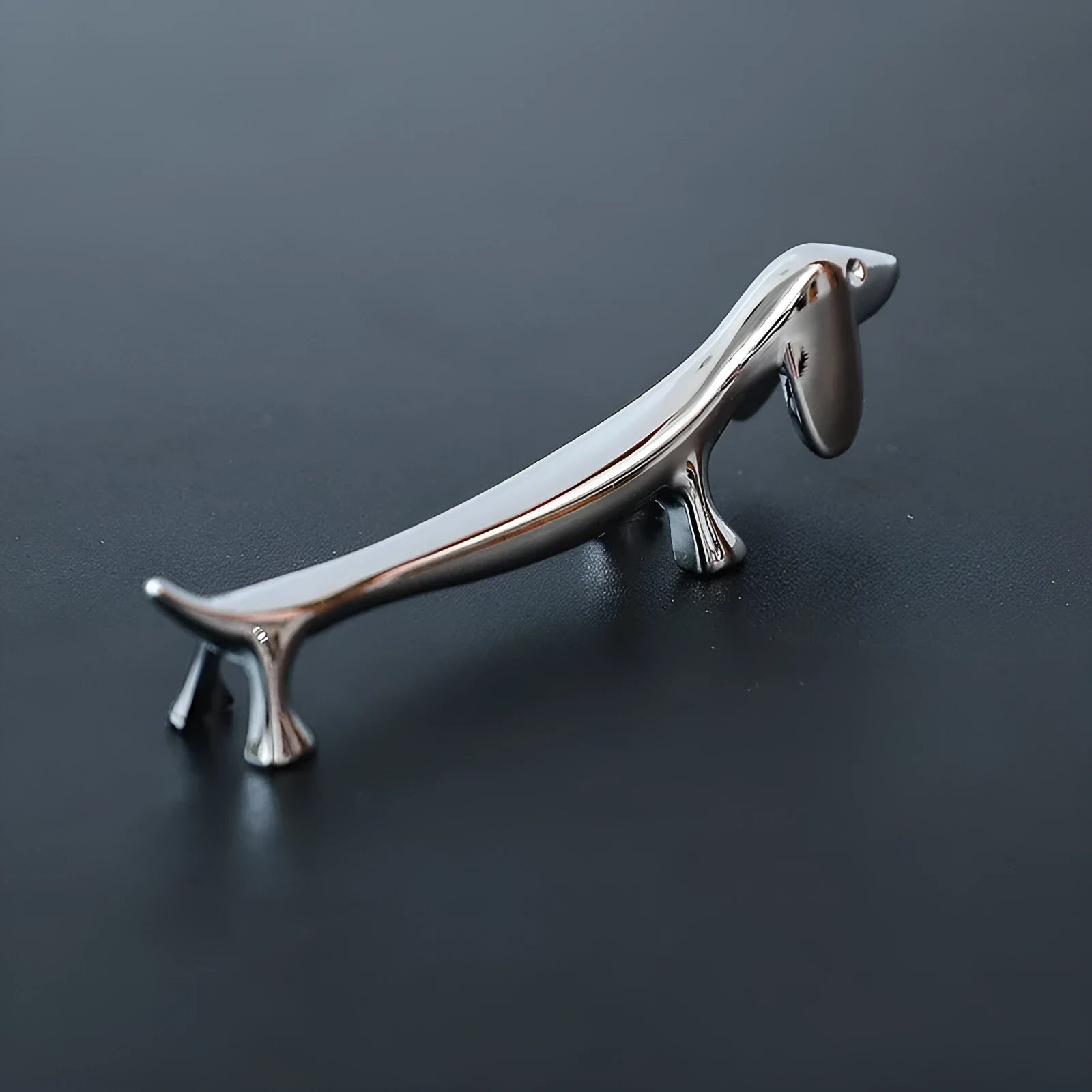 Silver zinc alloy sausage dog chopstick rest on a table