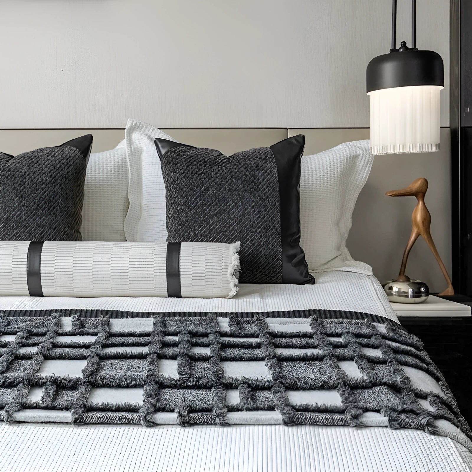 Modern minimalist grey and white plaid bed runner set with pillowcase and round leather pillow on bed