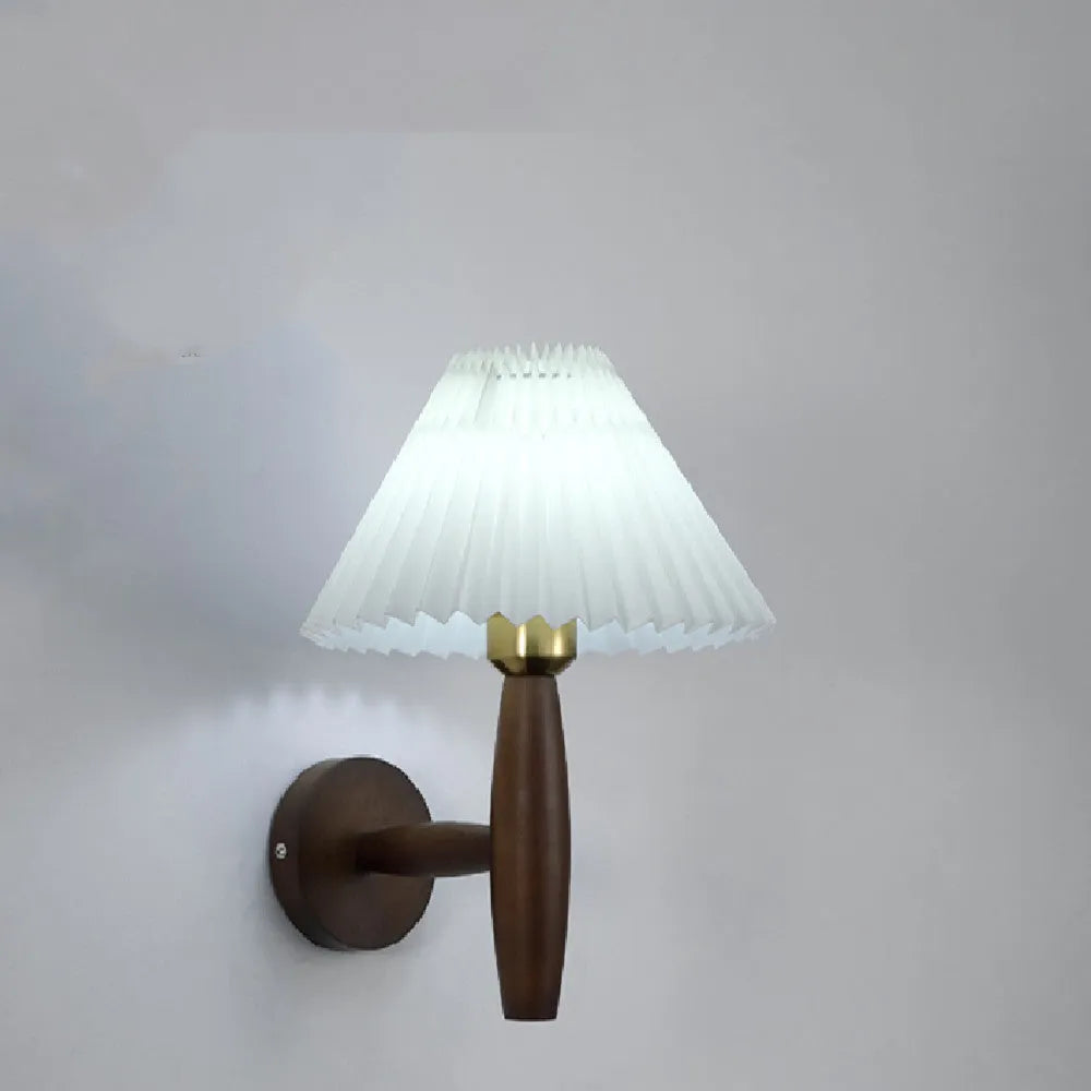 American retro walnut wood wall lamp with fabric shade on a wooden bedside table