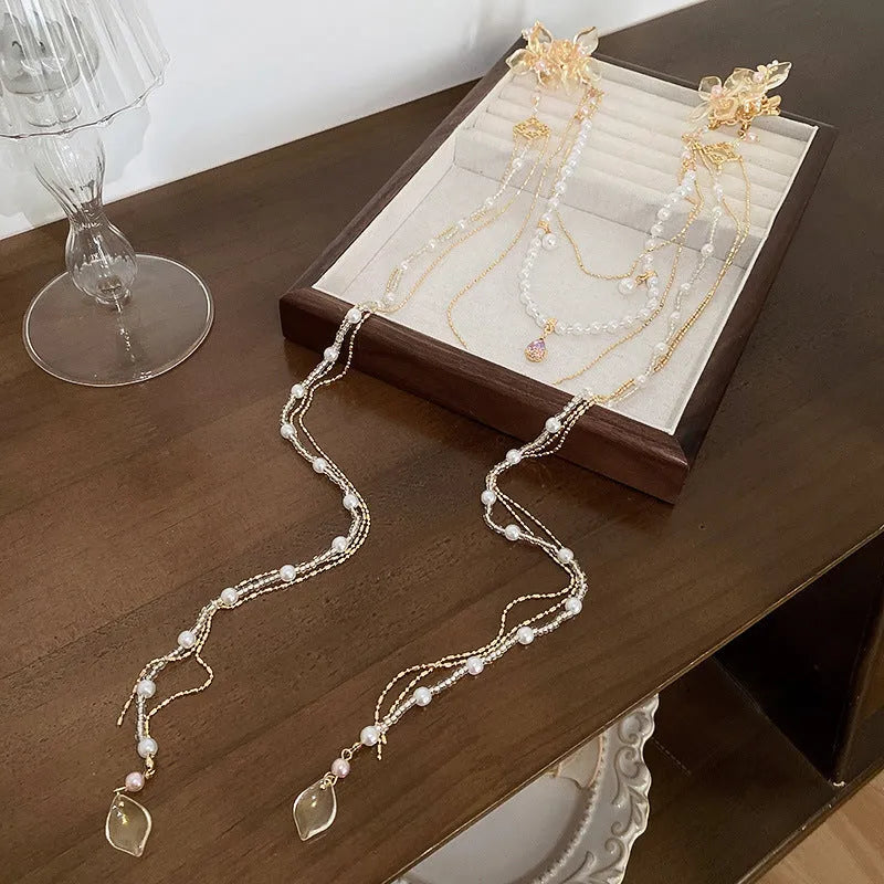 Gold grip hairpin with white pearl diamond flower and long clear tassel decoration.