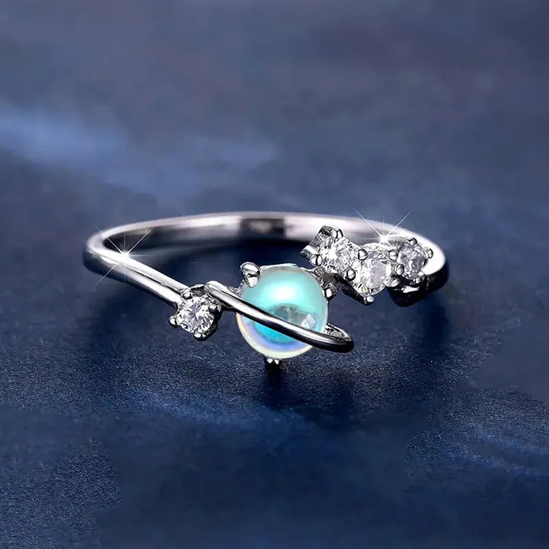 Geometric planet shaped copper ring with electroplated white gold finish on white background