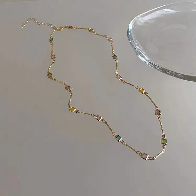 Square colour clavicle chain necklace with geometric crystal pendant in gold or white K finish.