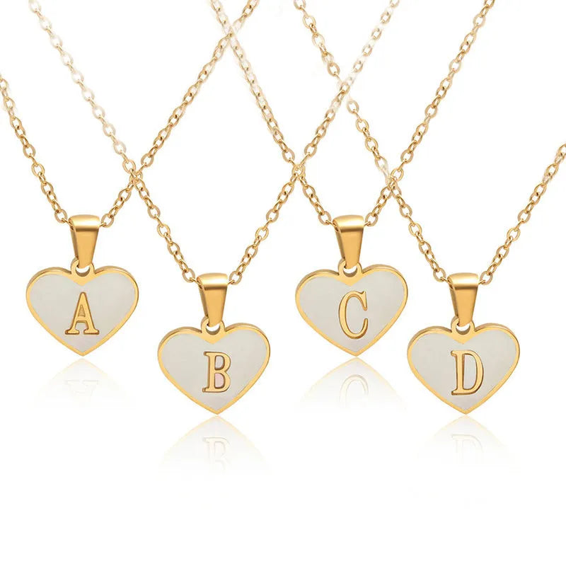 Gold plated heart-shaped necklace with a personalised initial letter and white shell detail on a 50cm adjustable chain.