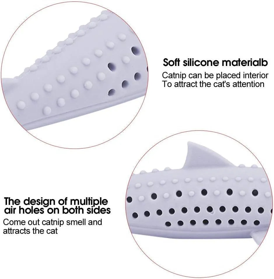 Green silicone fish-shaped cat chew toy with side holes on a white background.