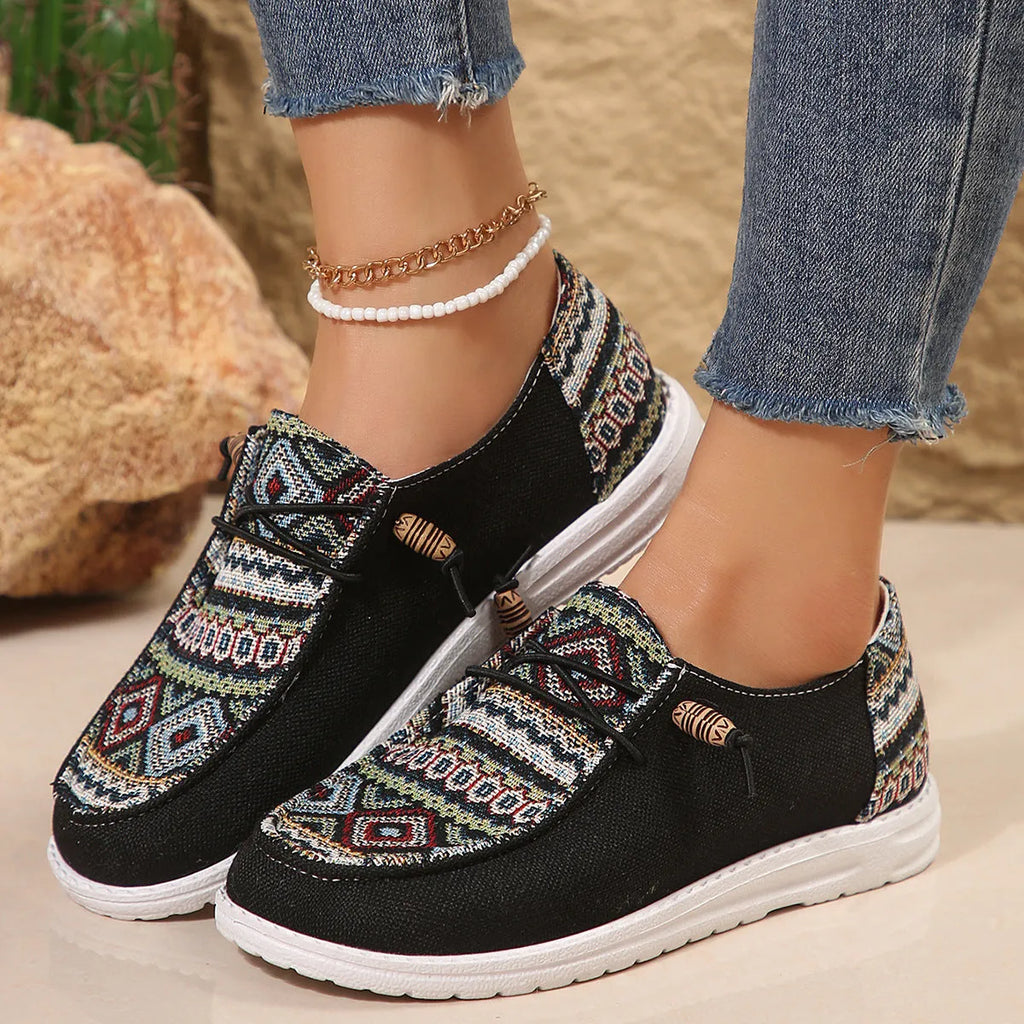 Women's black round toe flat shoes with a low-top PU upper and rubber sole on a plain background.