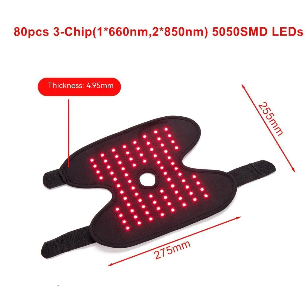 Black ankle heating wrap with red light therapy and USB cable on flat surface