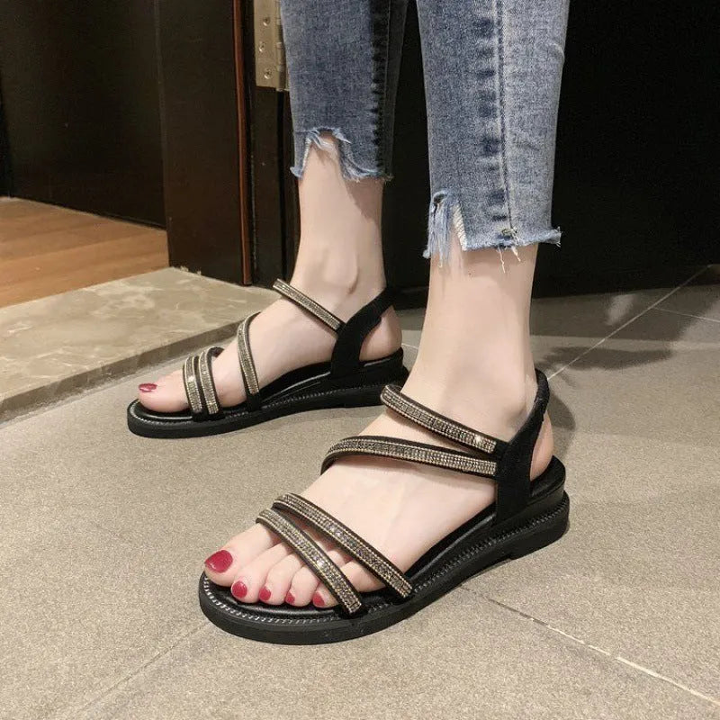 Women's silver Korean style flat sandals with elastic band and rhinestone decoration on a rubber sole.