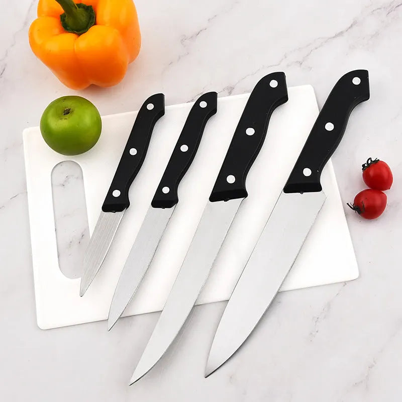 Stainless steel knife with 17.5cm blade and black A-style cutting board on kitchen countertop