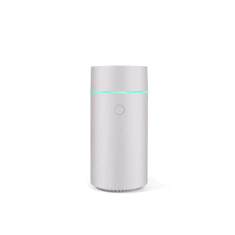 USB ultrasonic aroma diffuser 80ml with RGB LED lights in black, on a desk next to essential oil bottles