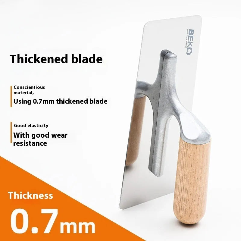 Stainless steel cement scraper with a wooden handle for applying putty to walls and floors.